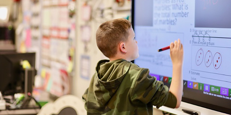 Young student at the board